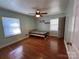 Cozy bedroom with wood floors, natural light from two windows and a ceiling fan for comfort at 2009 Hickory Grove Rd, Gastonia, NC 28056