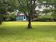 Inviting front yard with well-maintained lawn and mature trees, creating a picturesque and tranquil environment at 2009 Hickory Grove Rd, Gastonia, NC 28056