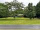 Expansive front yard featuring lush green lawn and mature trees, offering a serene and inviting curb appeal at 2009 Hickory Grove Rd, Gastonia, NC 28056