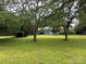 Spacious front yard showcasing mature trees and lush green grass, providing a park-like setting for the home at 2009 Hickory Grove Rd, Gastonia, NC 28056