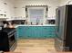 Traditional style kitchen with white and turquoise cabinets, stainless steel appliances, and wood floors at 2009 Hickory Grove Rd, Gastonia, NC 28056