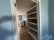 Bright laundry room with built in shelves and plank flooring at 2009 Hickory Grove Rd, Gastonia, NC 28056