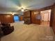 Open living space with wood-paneled walls and a brick fireplace at 2009 Hickory Grove Rd, Gastonia, NC 28056