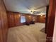 Spacious living room with cozy seating, fireplace and wood paneling at 2009 Hickory Grove Rd, Gastonia, NC 28056