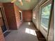 Enclosed porch featuring brick walls, large windows, and natural light with door to outside at 2009 Hickory Grove Rd, Gastonia, NC 28056