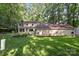 View of the rear of the house, showing well-maintained lawn, mature landscaping, and a cozy, inviting outdoor space at 201 Scalybark Trl, Concord, NC 28027