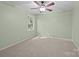 Cozy bedroom features a ceiling fan, neutral carpet, and natural light at 201 Scalybark Trl, Concord, NC 28027