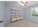 Sun-filled bedroom with carpet and shelving unit, providing storage solutions at 201 Scalybark Trl, Concord, NC 28027