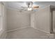 Neutral bedroom featuring carpet, modern ceiling fan, and a bright window at 201 Scalybark Trl, Concord, NC 28027