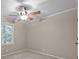 Neutral bedroom featuring a window with leafy tree views for natural light at 201 Scalybark Trl, Concord, NC 28027