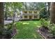 Charming two-story home with a manicured lawn, lush landscaping, and a detached garage with ample parking at 201 Scalybark Trl, Concord, NC 28027