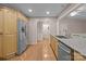 Well-lit kitchen features stainless steel appliances, granite countertops, and honey colored cabinetry with a wood floor at 201 Scalybark Trl, Concord, NC 28027