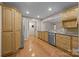 Well-lit kitchen features stainless steel appliances, granite countertops, and honey colored cabinetry with a wood floor at 201 Scalybark Trl, Concord, NC 28027