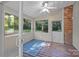 Enclosed sunroom featuring wood floors, large windows, and brick wall at 201 Scalybark Trl, Concord, NC 28027