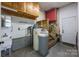 Utility room features a sink, water filtration system, and access to stairs at 201 Scalybark Trl, Concord, NC 28027