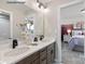 Modern bathroom with a double sink vanity, decorative vases and lighting fixtures, and an open doorway to an adjacent bedroom at 2046 Sabra St # Cwo0006, Gastonia, NC 28054