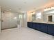 Bathroom with double vanities, marble floor, and large glass enclosed shower at 2046 Sabra St # Cwo0006, Gastonia, NC 28054