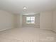 Bright, open bedroom with carpeted floors and a large window offering natural light at 2046 Sabra St # Cwo0006, Gastonia, NC 28054
