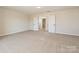 Large primary bedroom boasts carpeted floors, neutral walls, and adjacent bath and closet access at 2046 Sabra St # Cwo0006, Gastonia, NC 28054