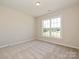 Bedroom with carpet flooring and a window allowing ample natural light at 2046 Sabra St # Cwo0006, Gastonia, NC 28054