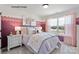 Bright bedroom features a plush bed, rainbow decor, a window and stylish furniture creating a cozy and inviting atmosphere at 2046 Sabra St # Cwo0006, Gastonia, NC 28054