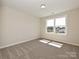 Bedroom boasts carpeting, natural light, and a view of the trees and neighborhood outside at 2046 Sabra St # Cwo0006, Gastonia, NC 28054
