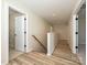 Bright hallway featuring hardwood floors, white trim, and natural light from an open door at 2046 Sabra St # Cwo0006, Gastonia, NC 28054