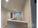 Upstairs hallway features hardwood floors, natural light from a window, and doors leading to various rooms in the home at 2046 Sabra St # Cwo0006, Gastonia, NC 28054