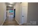 Bright hallway with modern flooring and neutral walls, leading to a well-lit living area, creating a seamless flow at 2046 Sabra St # Cwo0006, Gastonia, NC 28054