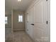 Hallway with carpet, featuring doors and windows offering natural light and access to other rooms at 2046 Sabra St # Cwo0006, Gastonia, NC 28054