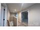 Bright hallway with light wood floors and doors leading to other rooms in the home, and a stair case leading down at 2046 Sabra St # Cwo0006, Gastonia, NC 28054