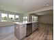 Open kitchen with a central island featuring a sink and stainless steel dishwasher at 2046 Sabra St # Cwo0006, Gastonia, NC 28054