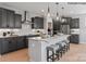 This kitchen features gray cabinets, stainless steel appliances and a large island with bar stool seating at 2046 Sabra St # Cwo0006, Gastonia, NC 28054