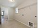Tiled laundry room with a window, utility sink and convenient access to other areas of the house at 2046 Sabra St # Cwo0006, Gastonia, NC 28054