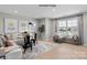 Cozy living room with a sectional sofa, hardwood floors, and a window seat with views of the community at 2046 Sabra St # Cwo0006, Gastonia, NC 28054