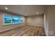 A living space with three windows, hardwood floors, and lots of natural light at 2046 Sabra St # Cwo0006, Gastonia, NC 28054