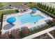 Aerial view of a community pool with lounge chairs, umbrellas, and well manicured landscaping at 2046 Sabra St # Cwo0006, Gastonia, NC 28054