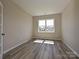 Neutral room with hardwood flooring and natural light streaming through a large window at 2046 Sabra St # Cwo0006, Gastonia, NC 28054