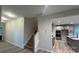View of the staircase leading to an open-concept kitchen featuring gray cabinets, creating an inviting space at 2046 Sabra St # Cwo0006, Gastonia, NC 28054