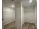 Spacious walk-in closet features built-in shelving and wood look flooring at 2046 Sabra St # Cwo0006, Gastonia, NC 28054