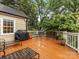 Spacious backyard deck featuring a grill, bench, and outdoor seating, perfect for entertaining in style at 2432 Hassell Pl, Charlotte, NC 28209