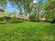 Expansive backyard features lush green grass and mature trees, offering a private oasis for outdoor enjoyment at 2432 Hassell Pl, Charlotte, NC 28209