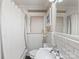 Compact bathroom featuring white subway tile, traditional fixtures, and a bright window at 2432 Hassell Pl, Charlotte, NC 28209