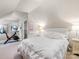 Attic bedroom includes exercise equipment, closet, and a bed with a padded headboard at 2432 Hassell Pl, Charlotte, NC 28209