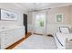 Well-lit bedroom showcases a modern dresser, bright white wainscoting, and a calming color palette at 2432 Hassell Pl, Charlotte, NC 28209