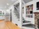 Spacious entryway with hardwood floors, staircase, and built-in bookshelves at 2432 Hassell Pl, Charlotte, NC 28209