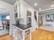 Stylish kitchen area with breakfast bar and seamless transition to dining room and stairs at 2432 Hassell Pl, Charlotte, NC 28209
