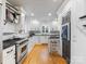 Charming kitchen design with stainless steel stove, butcher block countertops, and wood floors at 2432 Hassell Pl, Charlotte, NC 28209