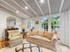 Bright and inviting living room features a large windows, sofa, and accent chair at 2432 Hassell Pl, Charlotte, NC 28209