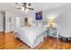 Bright main bedroom features hardwood floors, stylish decor, and a luxurious ensuite bathroom at 2432 Hassell Pl, Charlotte, NC 28209